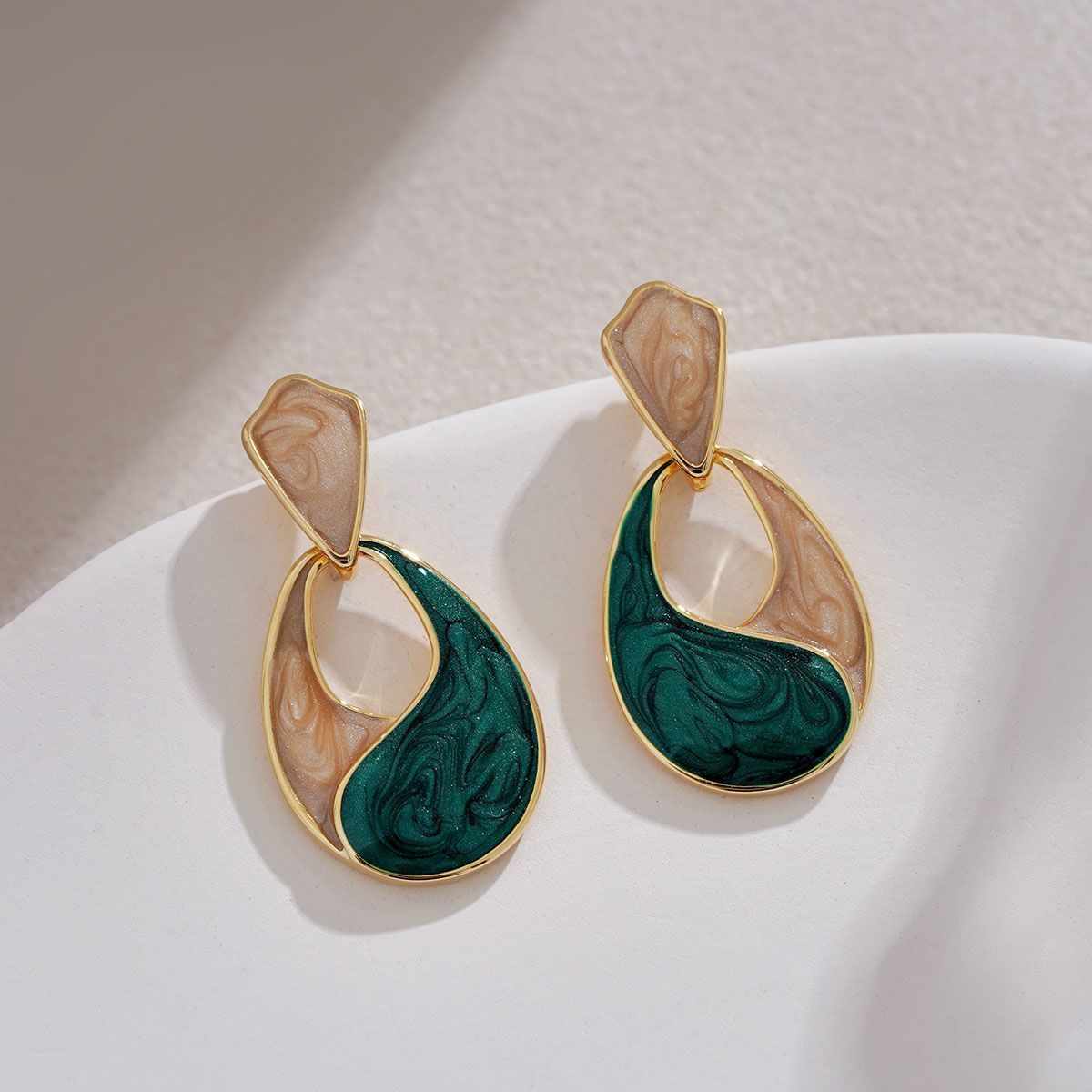 Elegant blue water drop stud earrings in a classic teardrop design, styled with a sophisticated French aesthetic.