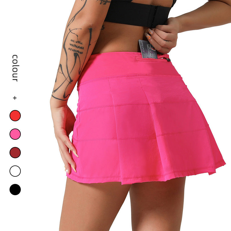 A woman wearing a vibrant hot pink pleated sports skort with a flat waistband and a hidden pocket, designed for tennis, yoga, and fitness activities.