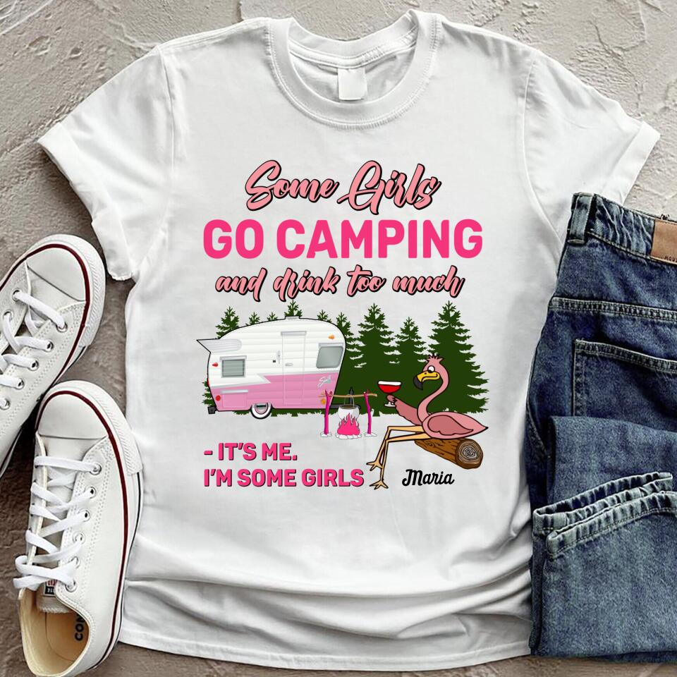White graphic t-shirt featuring a camping themed design with a pink flamingo and a camper, reading Some Girls Go Camping and Drink Too Much.