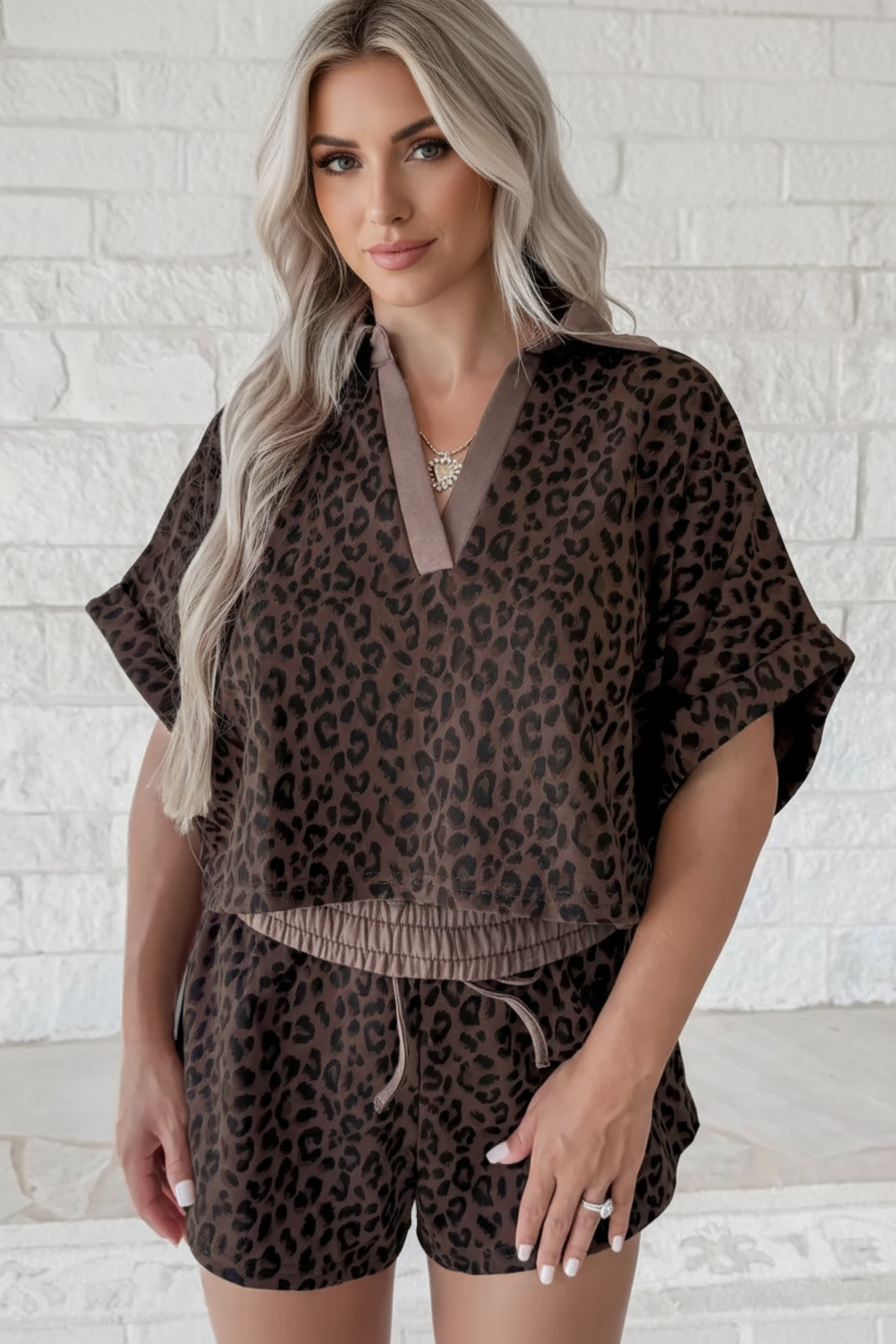 Woman wearing a brown leopard print two-piece set with a V-neck collared top and matching relaxed shorts.