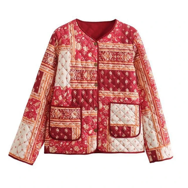 A vibrant red and cream patchwork quilted padded jacket for women, featuring intricate floral and geometric patterns and a button-up front.