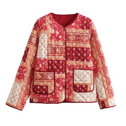 A vibrant red and cream patchwork quilted padded jacket for women, featuring intricate floral and geometric patterns and a button-up front.