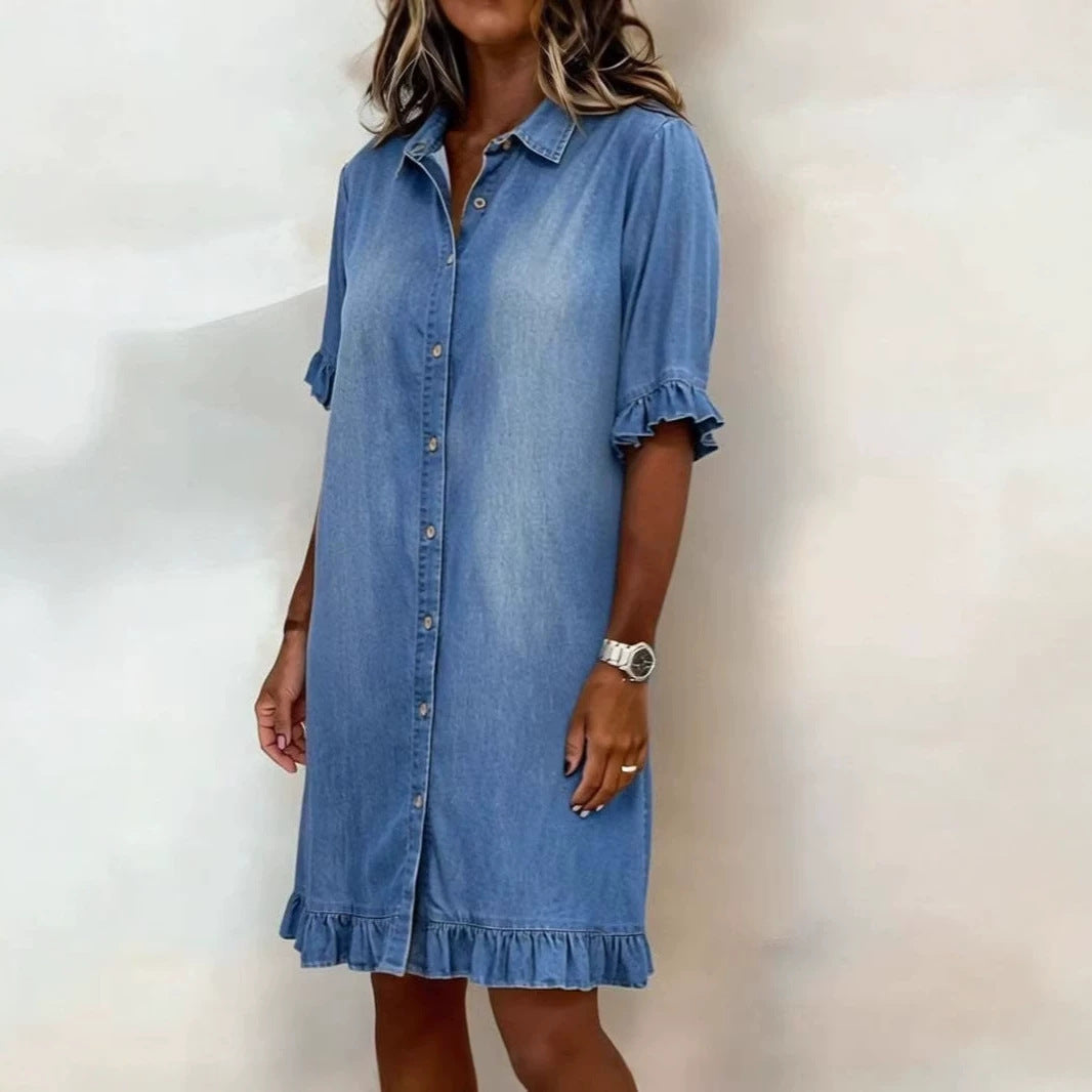 Model wearing a blue faux denim shirt dress with ruffle sleeve details and a button-front closure.