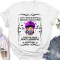 White and pink t-shirts featuring a graphic print of a woman with a crystal ball, moon, and text about being a sage burning, crystal collecting, tarot reading, moon admiring girl.