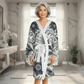 Elegant floral patterned long sleeve kimono robe with flowing bell sleeves worn for lounge wear