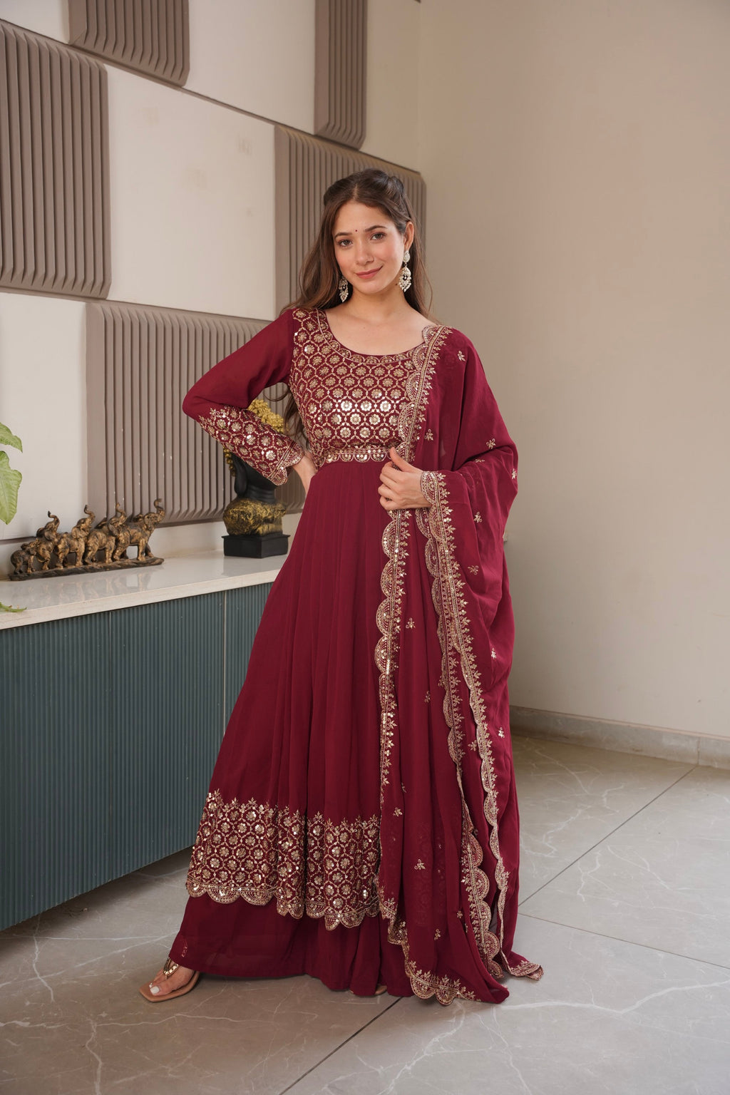 Maroon faux georgette Anarkali gown with heavy embroidery and sequins work, including sharara and dupatta.