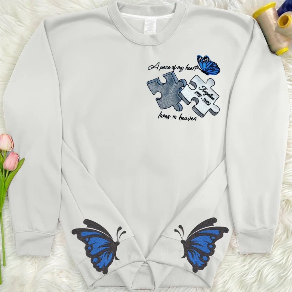 Personalized Memorial Side Bow Embroidered Sweatshirt - Memorial Gift Idea For Loss Of Mom/Dad - A Piece Of My Heart Lives In Heaven