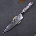8-inch Damascus steel chef knife with a vibrant turquoise handle on a wooden kitchen surface