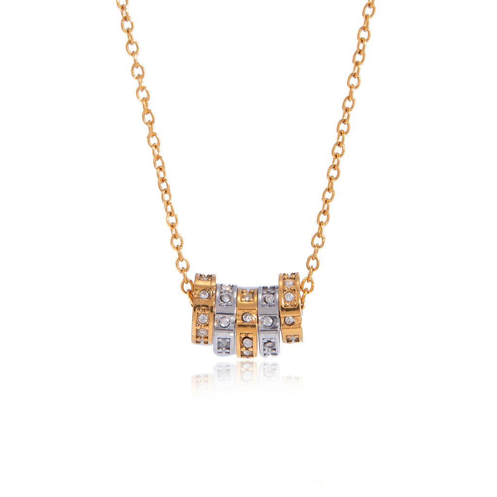 Minimalist stainless steel spinner pendant necklace featuring zircon accents in gold and silver finish.