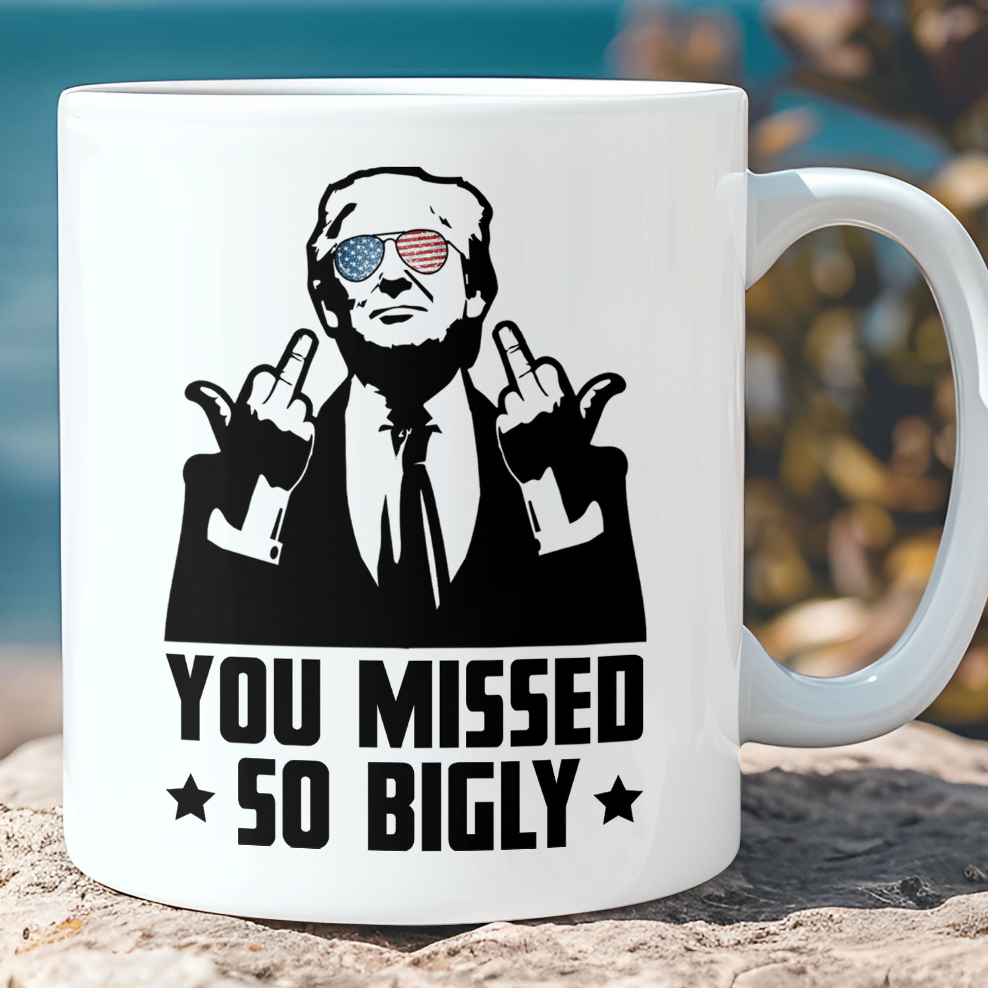White ceramic coffee mug featuring a graphic of Donald Trump wearing American flag sunglasses and giving the middle finger with text that reads You Missed So Bigly