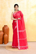 Rani pink handloom saree with zari border and embellishments draped elegantly.