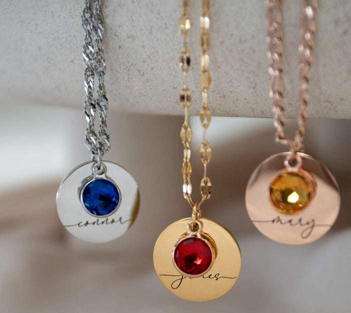 A personalized round pendant necklace with a birthstone, styled for a minimalist look.