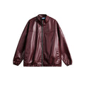 Front view of a women's burgundy faux leather zip-up bomber jacket with paneled design and stand-up collar.