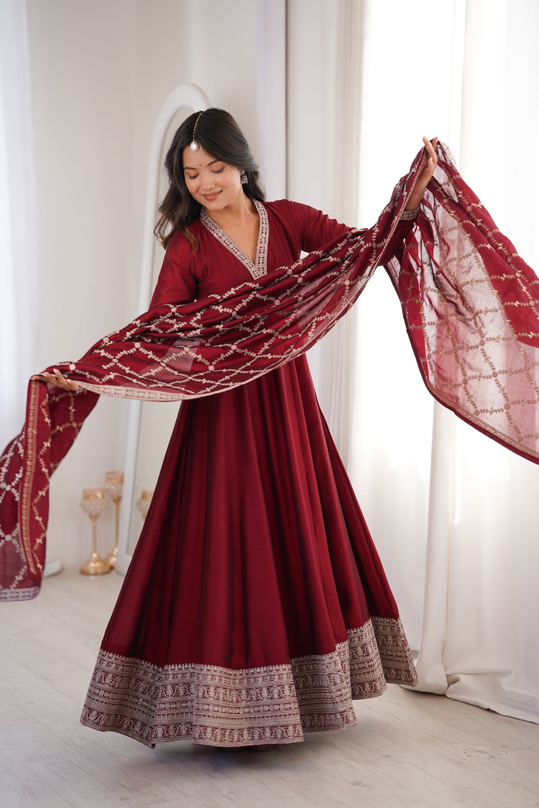 Front view of a Maroon Vichitra Silk Anarkali Gown with embroidery and dupatta
