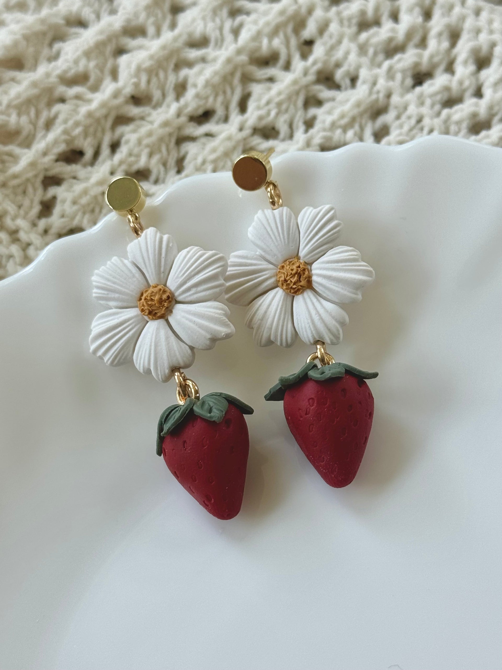 Bloom and Berry handmade polymer clay earrings with red and green floral motifs on gold hooks.