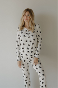 A woman wearing a long-sleeve bamboo pajama set with a black and white Yin Yang print.