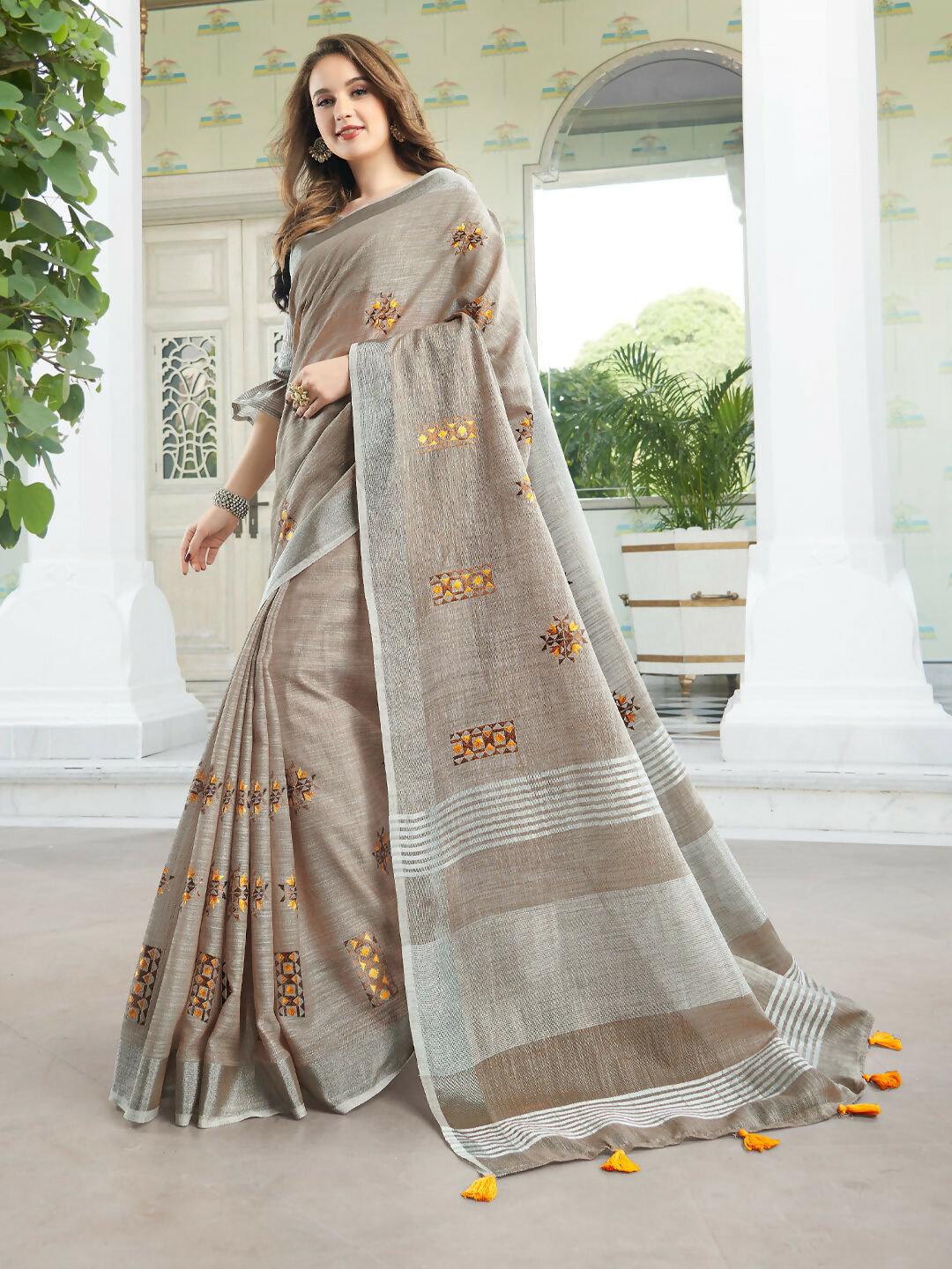 Light beige linen saree showcasing a clean, minimalist drape and matching blouse piece.