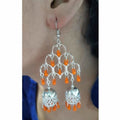 Traditional silver oxidized double jhumka earrings featuring long orange pearl drops.