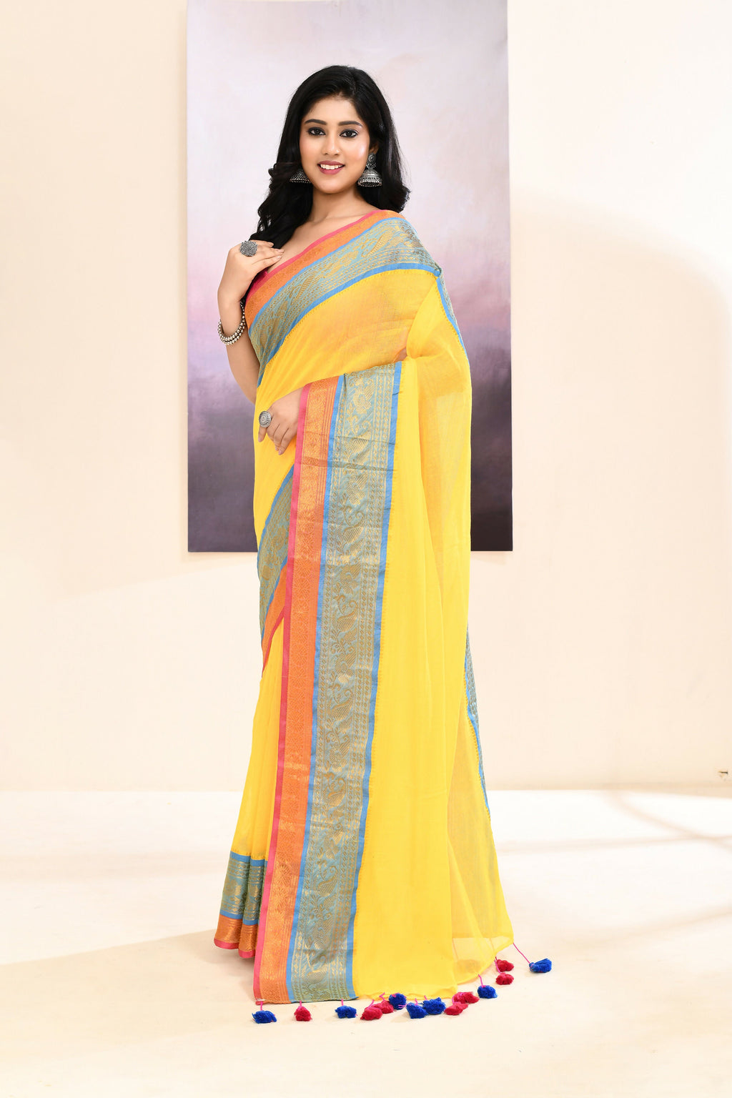 Yellow cotton saree featuring an ornate golden zari border