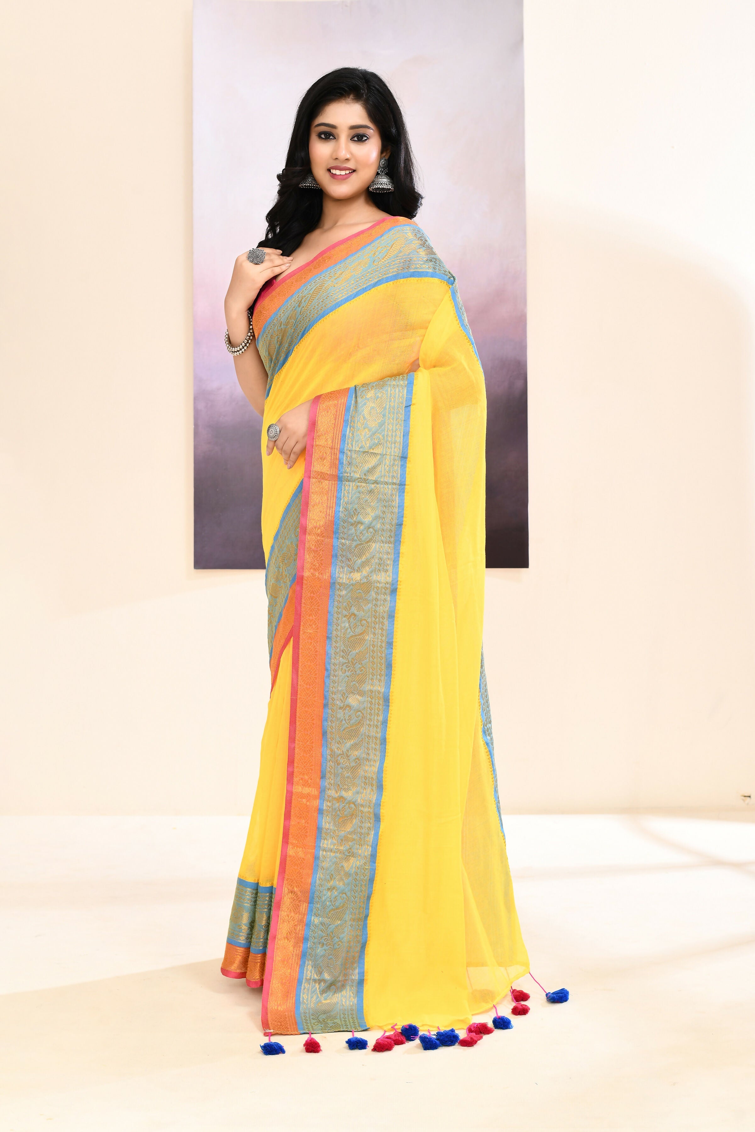 Yellow cotton saree featuring an ornate golden zari border