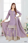 Woman wearing a lylac Chinon silk kurta set with metallic gold embroidery and three-quarter sleeves