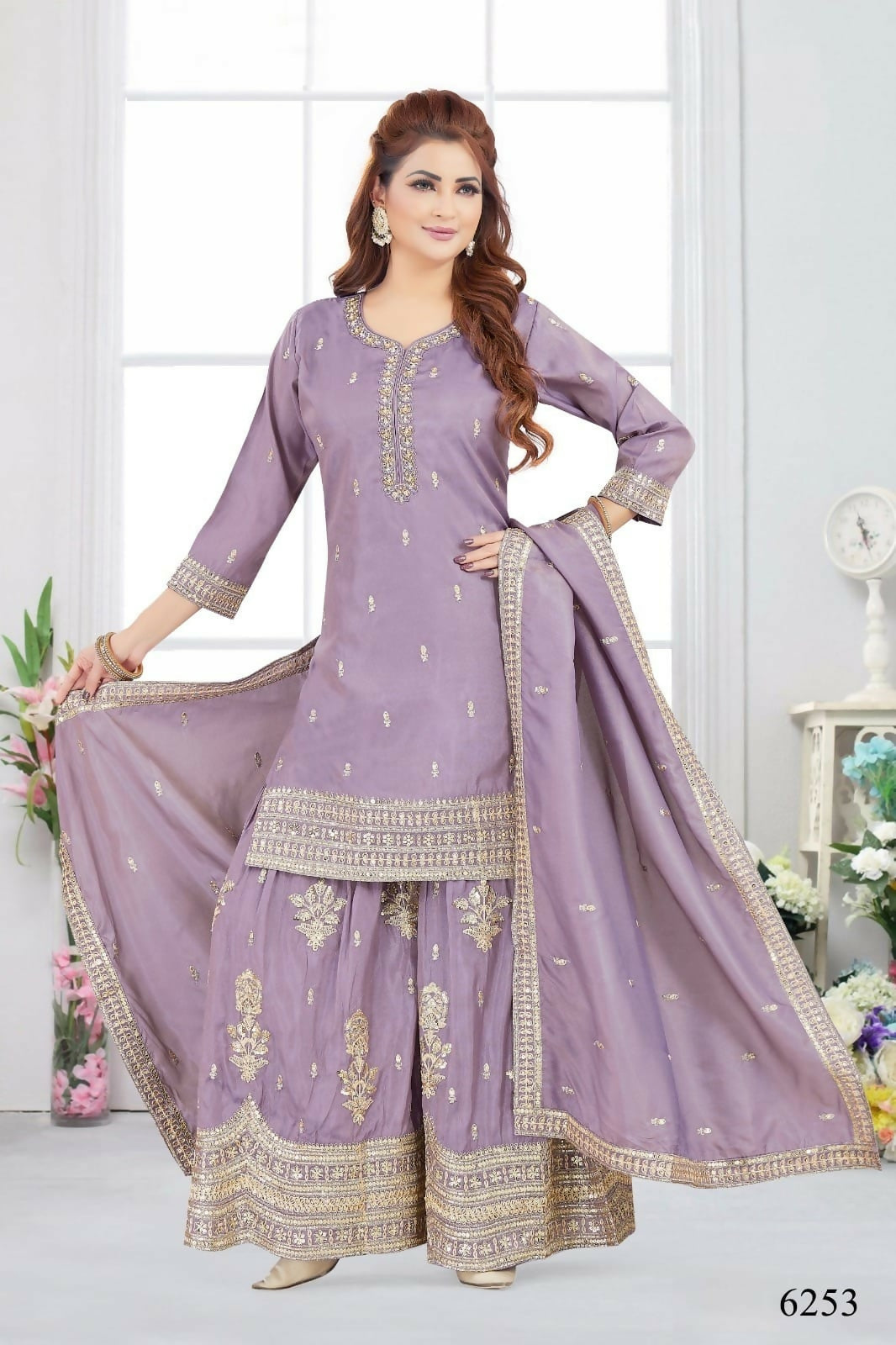 Woman wearing a lylac Chinon silk kurta set with metallic gold embroidery and three-quarter sleeves