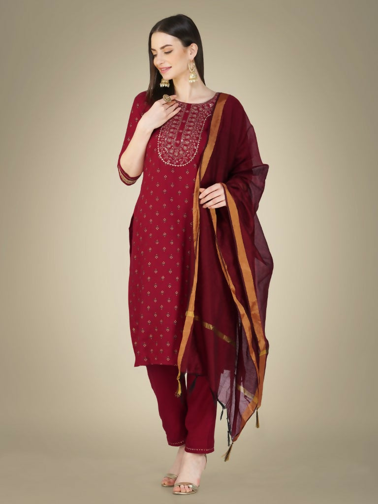 Women wearing a maroon straight kurta with embroidery and sequence work, paired with matching trousers and a dupatta.
