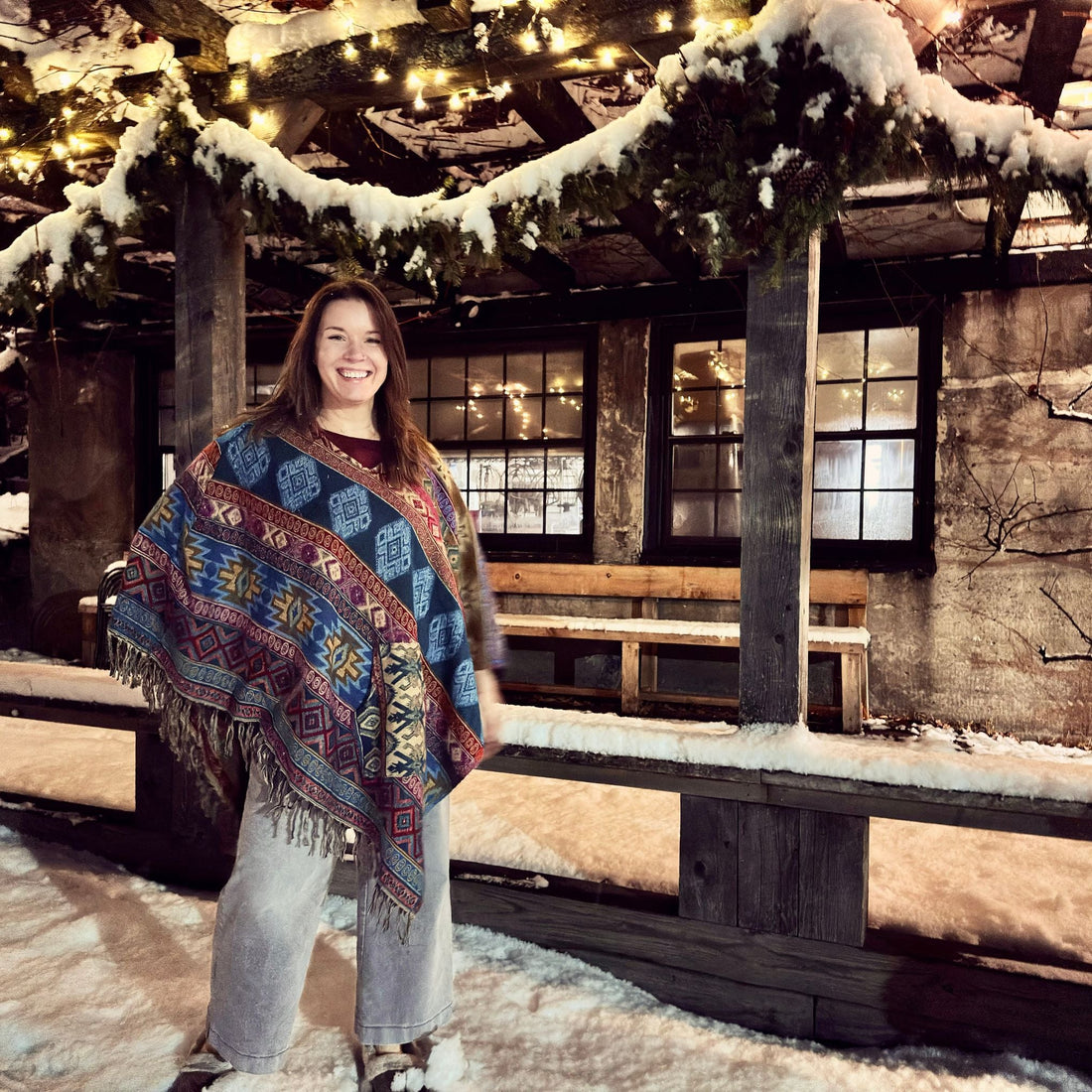 Model wearing a cozy Nanda hooded wool blend poncho in a boho style