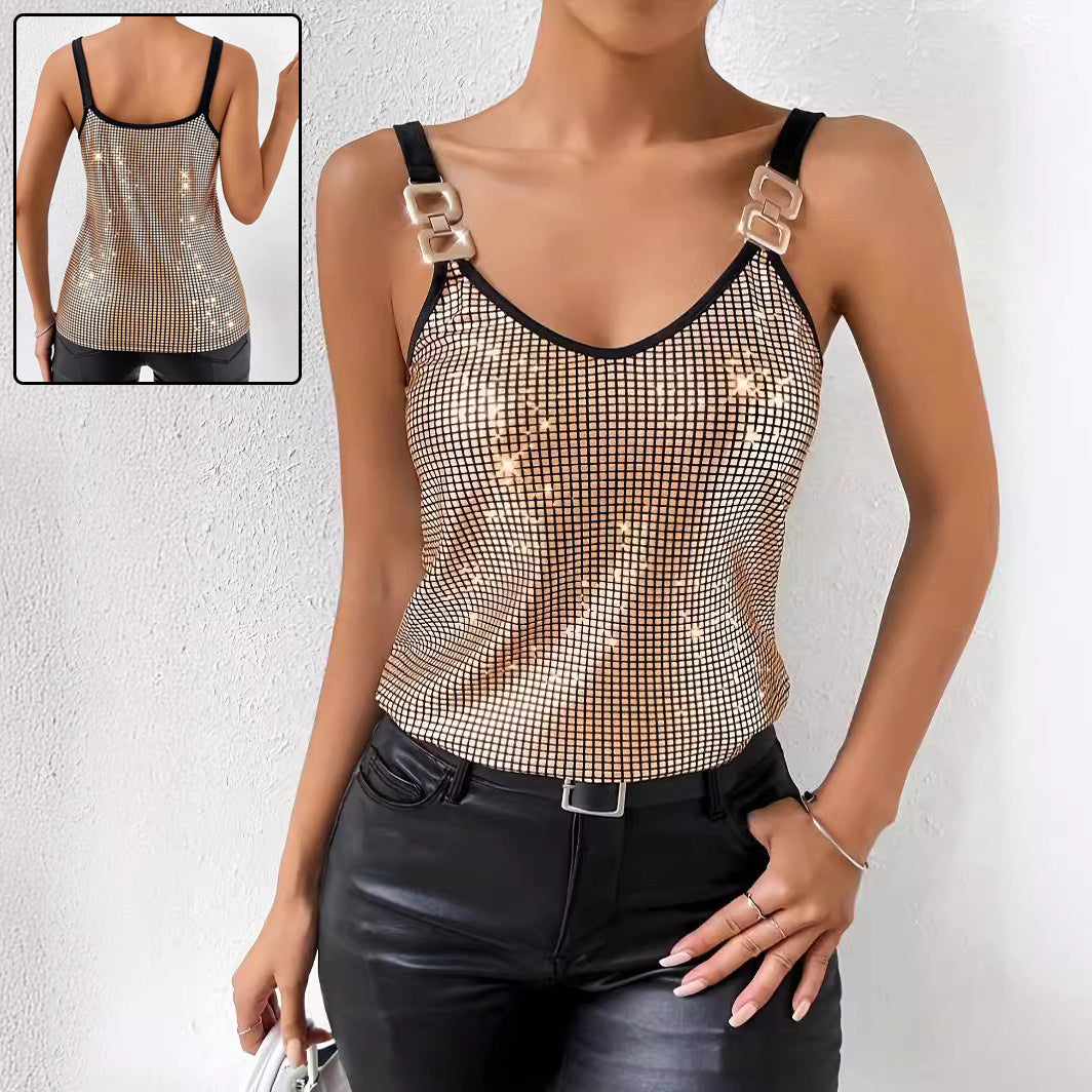 A woman wearing a gold sequined tank top with decorative chain shoulder straps, styled for an elegant evening look.