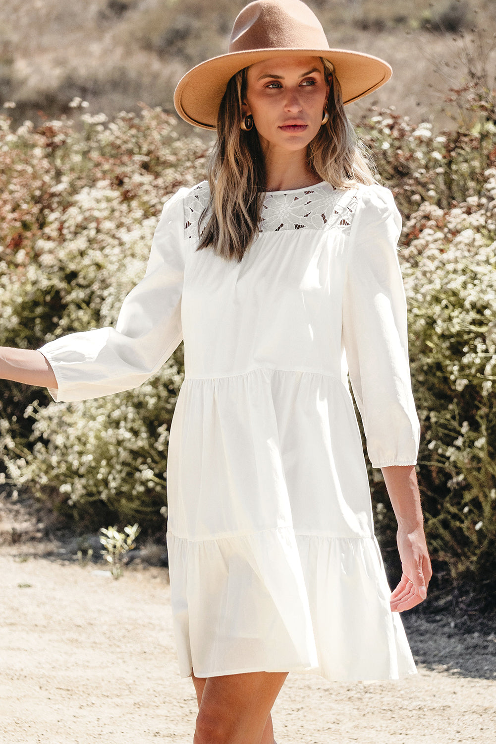 Front and back view of the white Whitley Floral Lace Patchwork Tiered Mini Dress on a model outdoors.