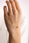 Personalized cursive name necklace with a custom birthstone charm on a delicate gold-toned chain.