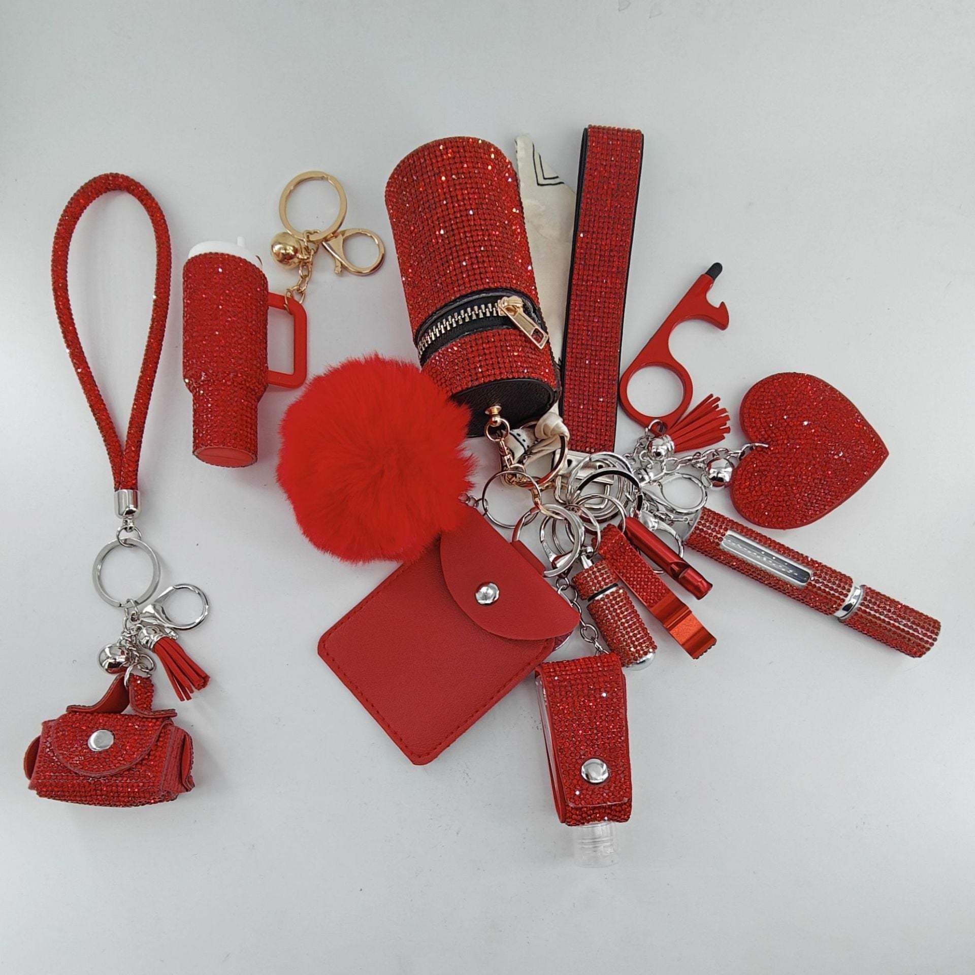 13-piece set of diamond inlay lipstick-shaped keychains in various colors displayed as bag charms.