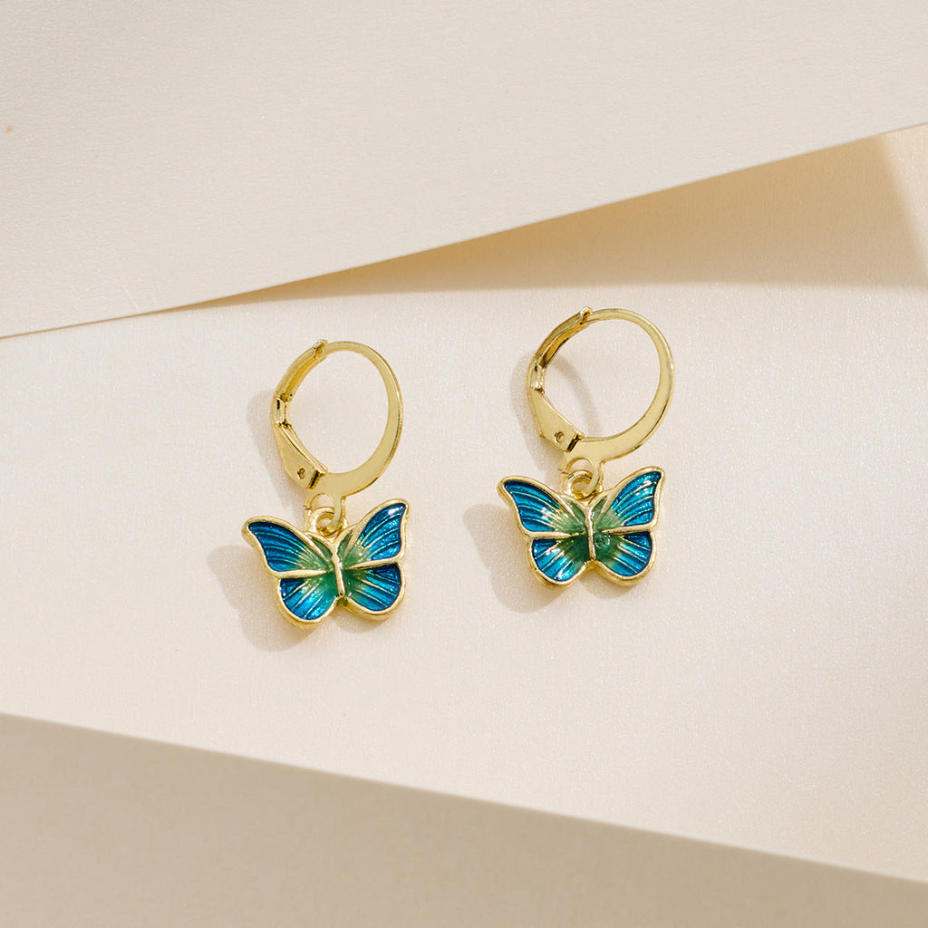 Petite gold butterfly earrings with dripping-oil detail, French-Korean design.