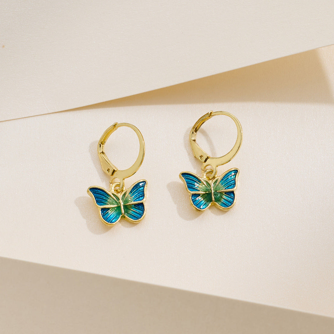 Petite gold butterfly earrings with dripping-oil detail, French-Korean design.