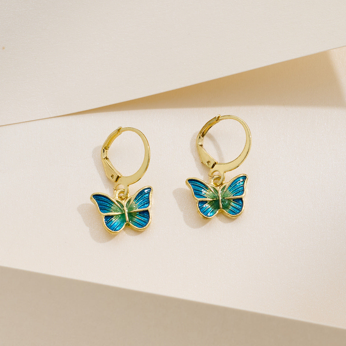 Petite gold butterfly earrings with dripping-oil detail, French-Korean design.