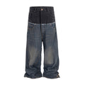 Front view of Wideboy Midnight Double Denim pants with a black top panel and distressed blue lower legs.