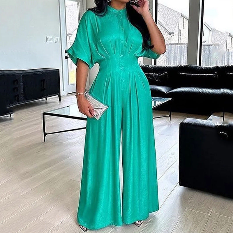 Elegant emerald green satin wide-leg jumpsuit with bat sleeves and collared neckline