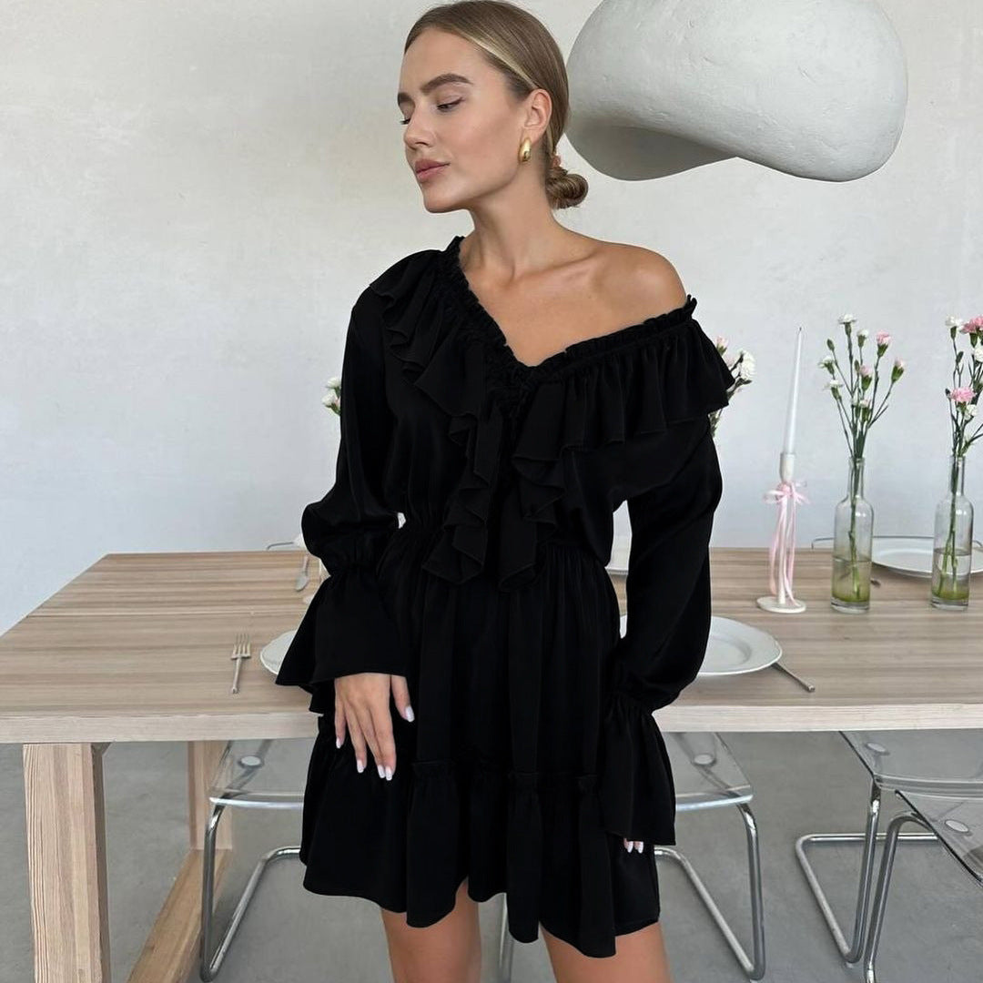 Woman wearing a solid color V-neck pleated ruffle dress with long flared sleeves and elastic waist