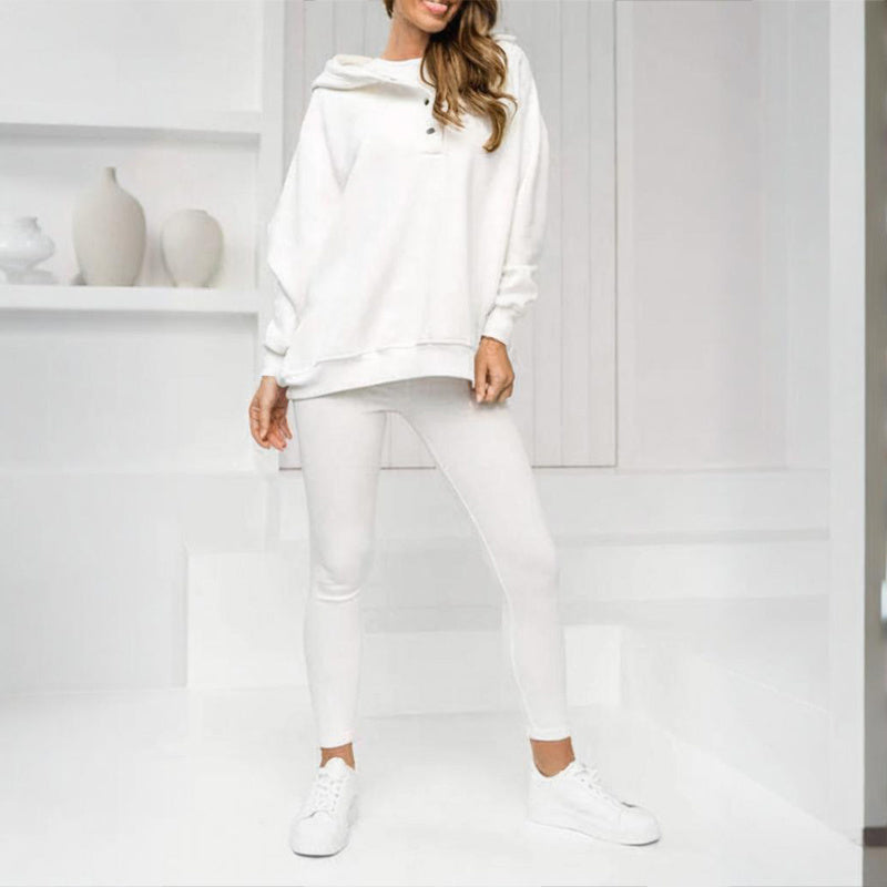 Women wearing a solid color three piece set featuring a hooded button-placket sweatshirt, vest, and slim-fit pants