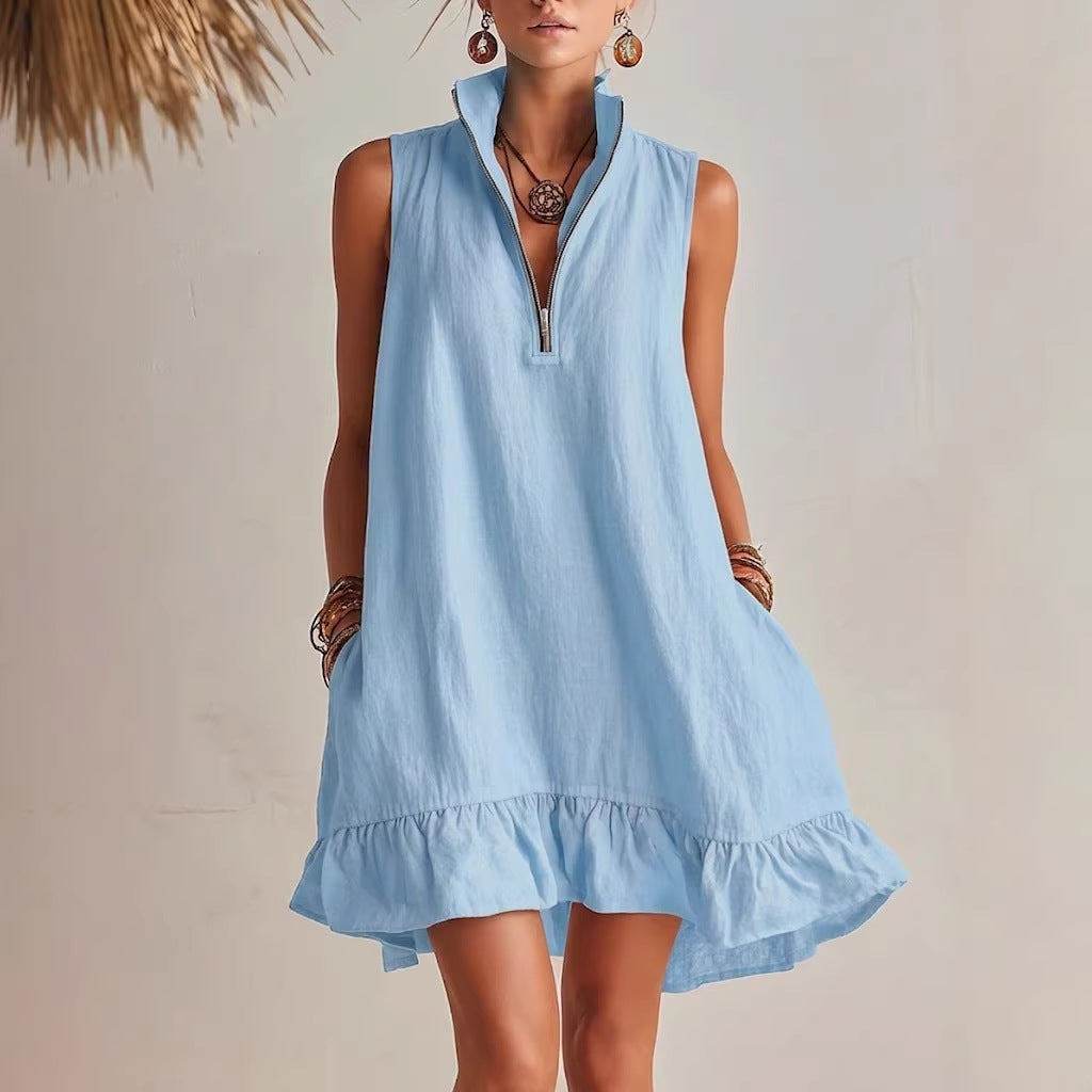 A woman wearing a light blue sleeveless mini dress with a half-zip front and ruffled hemline.