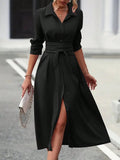 Black midi-length shirt dress with a collar, long sleeves, and a belted waist tie.