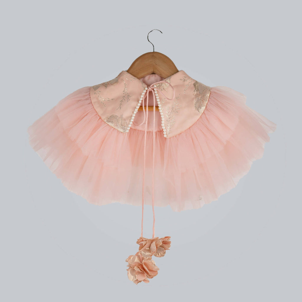Peach colored shrug with brocade chest, pearl detailing, and layered net frills.