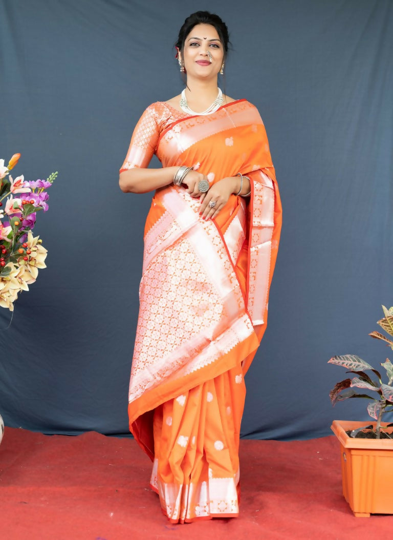 Vibrant orange soft Banarasi silk saree featuring delicate Zari weaving, paired with a matching orange blouse.