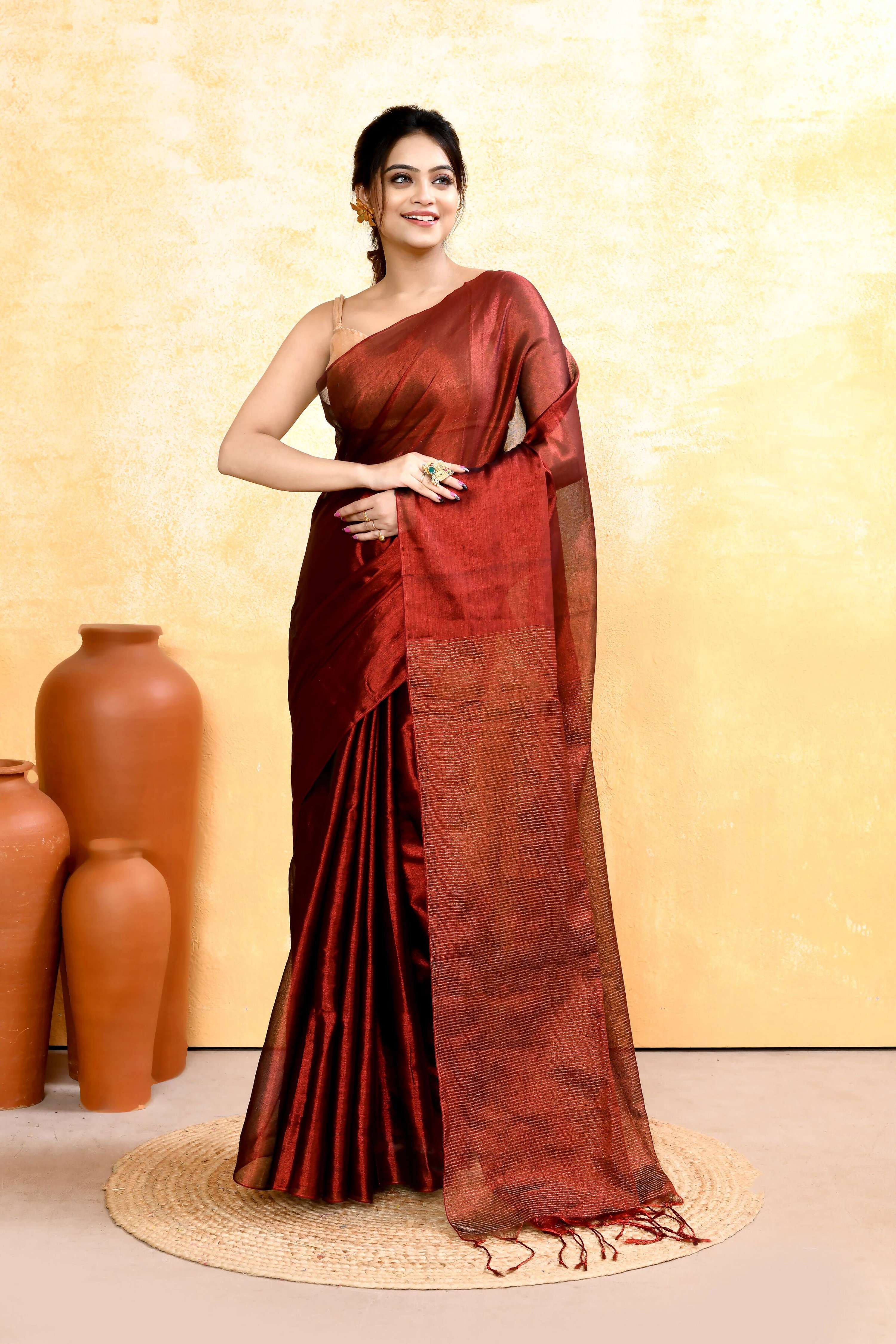 A woman wearing a Maroon Dual Tone Organic Tissue Saree with a matching blouse piece