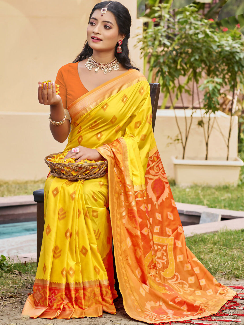 A beautiful yellow Pochampally silk saree with matching blouse piece displayed elegantly.
