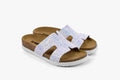 A pair of women's orthopedic slide sandals featuring a shimmering, glitter-effect pearlized leather upper and a cork-style footbed.