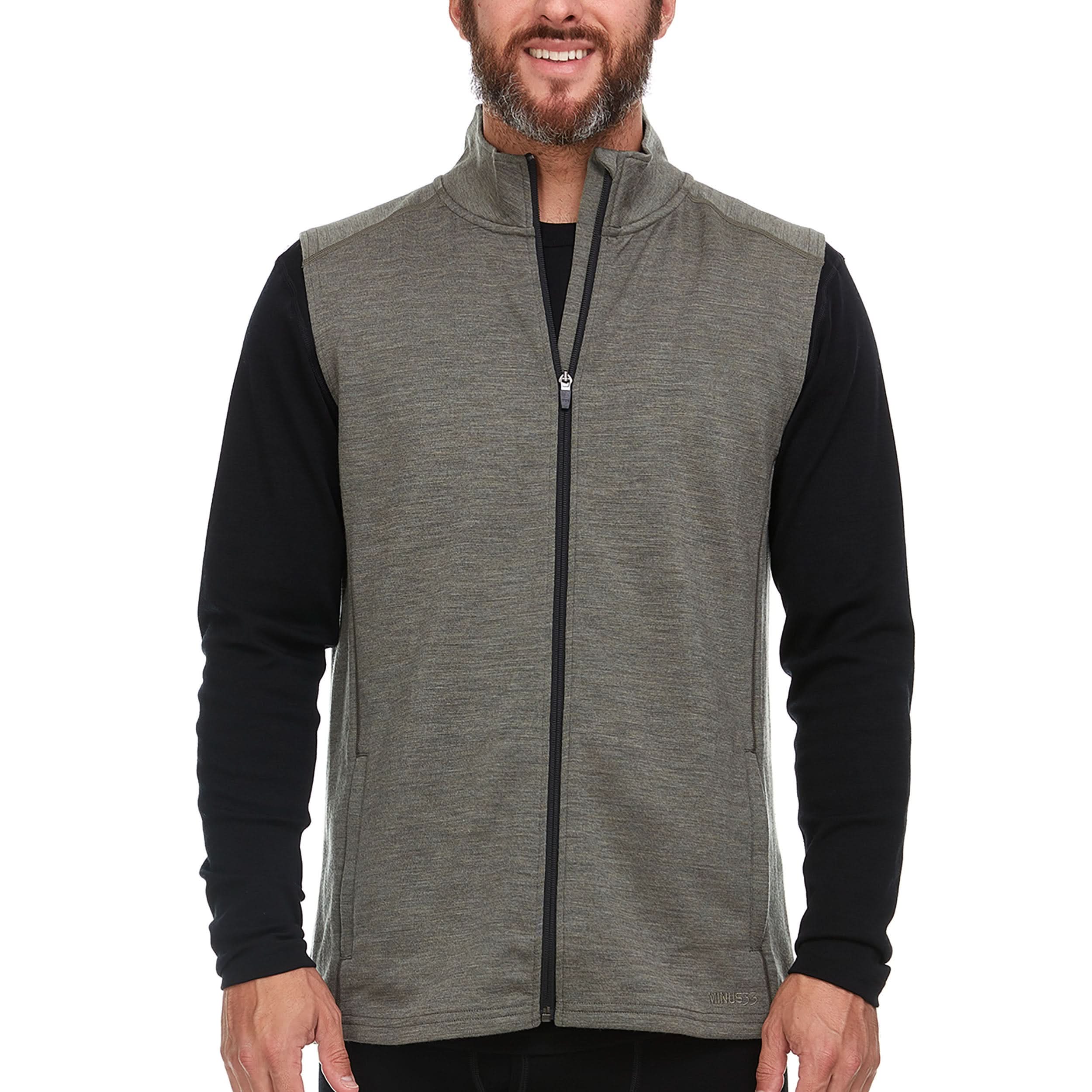 A man wearing an olive heavyweight 100% Merino wool vest outdoors, showing the knit texture and collared neckline.