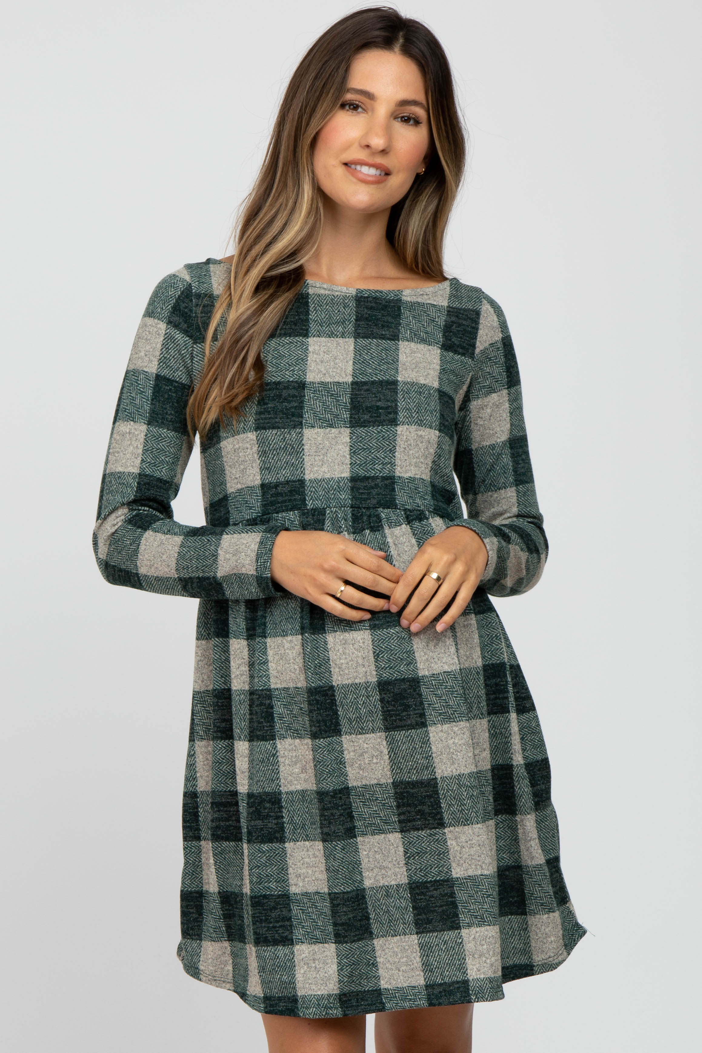 Model wearing a Forest Green Plaid Knit long sleeve maternity dress with a crew neckline.