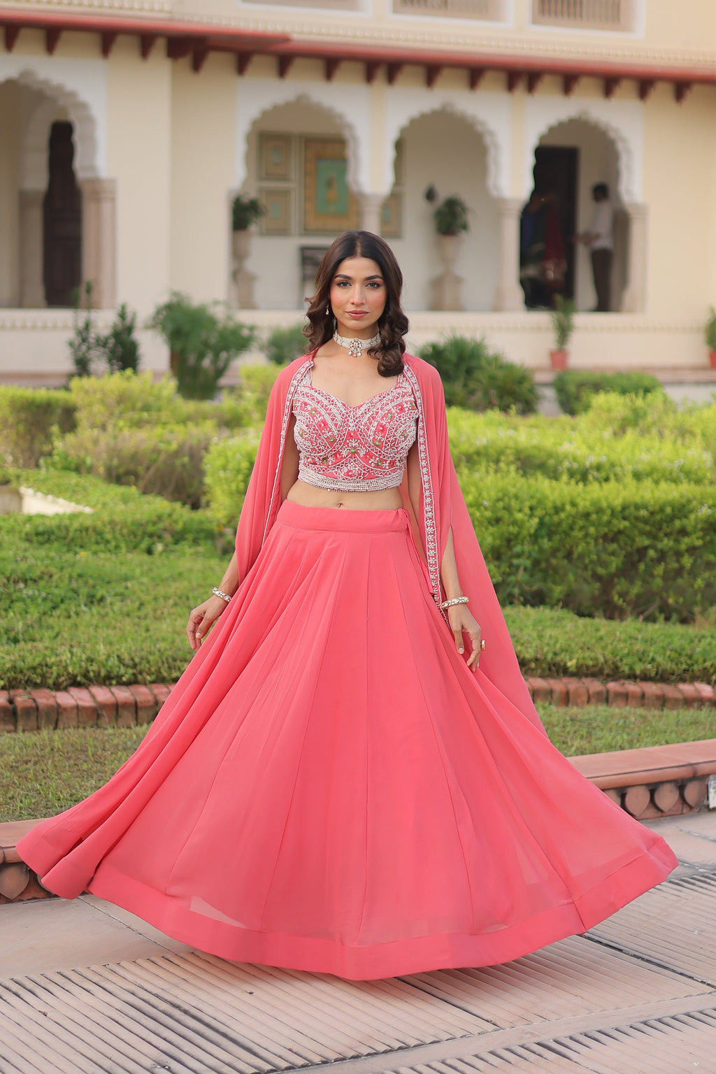 Peach faux georgette lehenga choli with a matching shrug