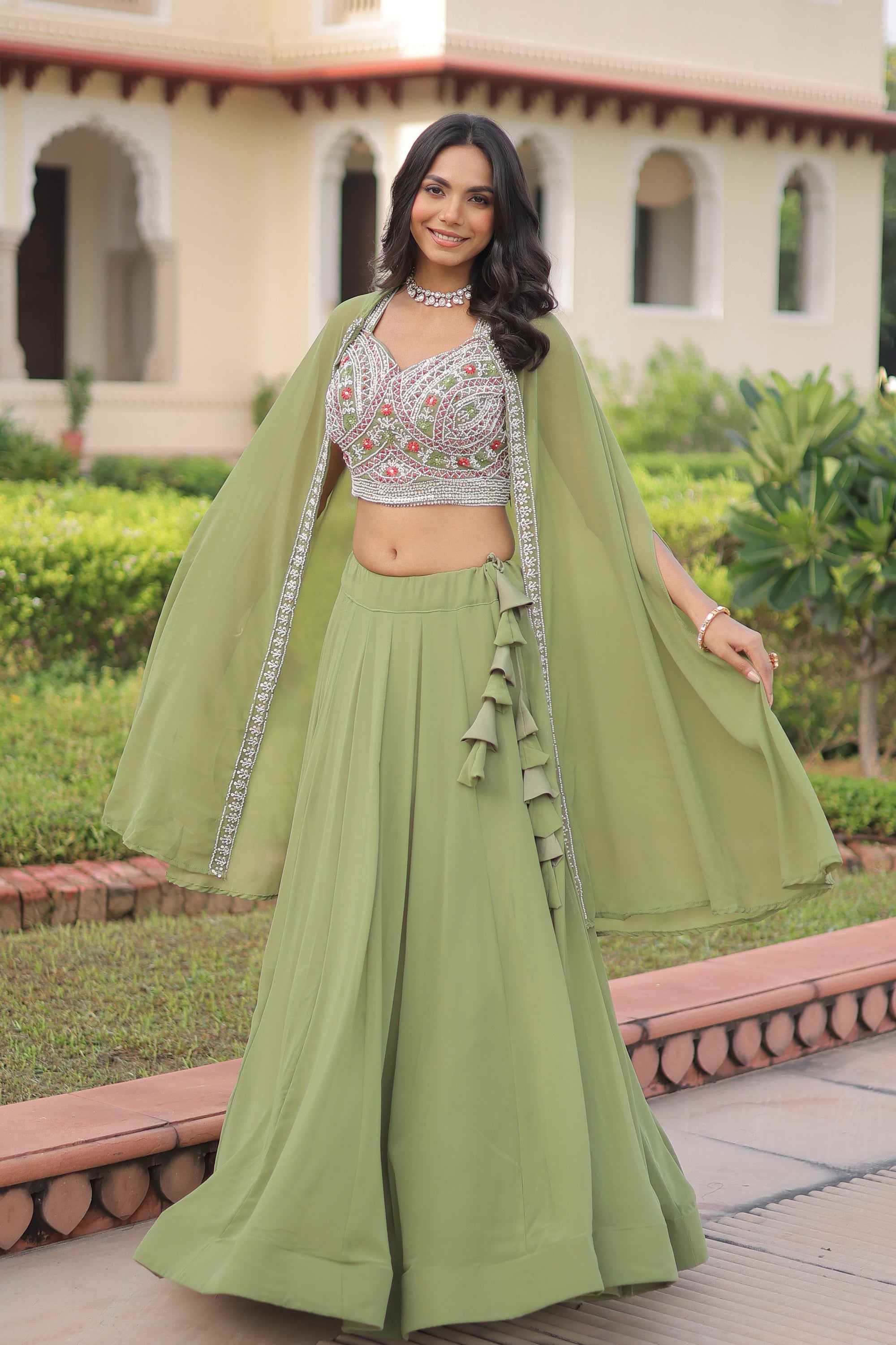 Pista colored Faux Georgette lehenga choli set with matching shrug and minimalist design